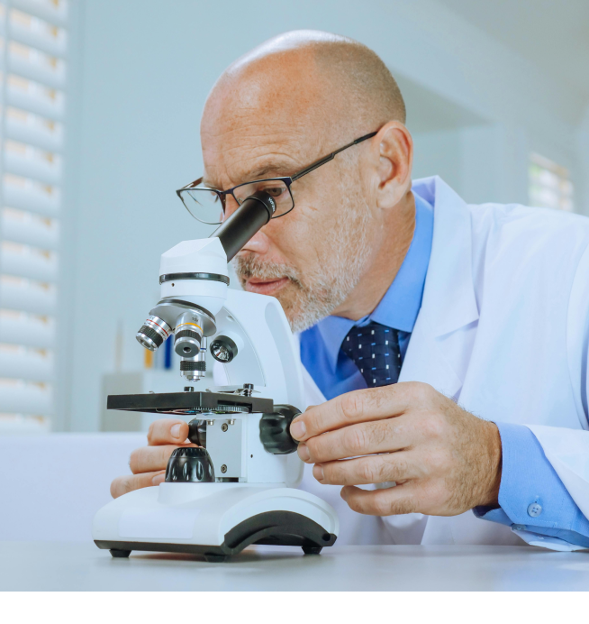 Researcher at a microscope
